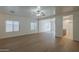 Spacious living room with wood floors, white walls, ceiling fan, and natural light at 29058 N Cactus Cir, San Tan Valley, AZ 85143