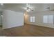 Open concept living room with wood floors, white walls, and bright overhead lighting at 29058 N Cactus Cir, San Tan Valley, AZ 85143