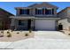Beautiful two-story home featuring a well-manicured front yard and two-car garage at 31866 N Bandit Rd, San Tan Valley, AZ 85143