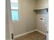 This laundry room features tile floors, window, built in shelf, and neutral colored walls at 31866 N Bandit Rd, San Tan Valley, AZ 85143
