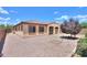 The backyard features gravel landscaping, a small tree, a tiled roof, and a covered patio at 36255 W Marin Ave, Maricopa, AZ 85138