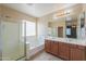 Bathroom featuring double sinks, large mirror, separate shower and tub at 36255 W Marin Ave, Maricopa, AZ 85138