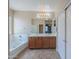Bathroom featuring double sinks, large mirror, and a separate tub at 36255 W Marin Ave, Maricopa, AZ 85138