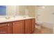 Bathroom featuring a vanity with double sinks and modern fixtures, and a toilet at 36255 W Marin Ave, Maricopa, AZ 85138