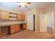 Comfortable bedroom with carpet flooring, a ceiling fan, and custom built-in cabinets and workspace at 36255 W Marin Ave, Maricopa, AZ 85138