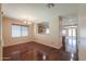 Dining area with wood floors, chandelier, and open view into the kitchen and living spaces at 36255 W Marin Ave, Maricopa, AZ 85138
