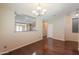 Cozy dining area with wood floors, neutral walls, and an opening to the kitchen at 36255 W Marin Ave, Maricopa, AZ 85138