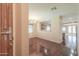 Open-concept floor plan with hardwood floors, chandelier lighting, and a view into the kitchen at 36255 W Marin Ave, Maricopa, AZ 85138