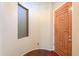 Foyer featuring hardwood floors and a beautifully crafted wood front door and sidelight window at 36255 W Marin Ave, Maricopa, AZ 85138
