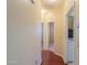 Inviting hallway with gleaming wood floors and neutral paint, connecting various rooms for seamless living at 36255 W Marin Ave, Maricopa, AZ 85138