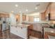 Spacious kitchen featuring stainless steel appliances, granite countertops, a central island, and wood flooring at 36255 W Marin Ave, Maricopa, AZ 85138