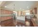 An open-concept kitchen boasts wood floors, lots of cabinet space, stainless steel appliances, and an island at 36255 W Marin Ave, Maricopa, AZ 85138