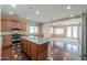 Bright kitchen featuring stainless steel appliances, granite counters, and dark wood flooring at 36255 W Marin Ave, Maricopa, AZ 85138