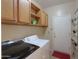 Laundry room featuring washer, dryer, cabinets, and outdoor access at 36255 W Marin Ave, Maricopa, AZ 85138