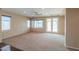 Neutral living room with carpet, a ceiling fan, and a French door leading to the backyard at 36255 W Marin Ave, Maricopa, AZ 85138