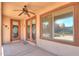 The patio has a ceiling fan and view of the backyard, desert landscaping, and outdoor furniture at 36255 W Marin Ave, Maricopa, AZ 85138