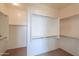 Walk-in closet with shelves and hanging racks for clothing storage at 36255 W Marin Ave, Maricopa, AZ 85138