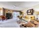 Bright living area with neutral carpet, fan, and sliding door to patio at 365 Leisure World --, Mesa, AZ 85206
