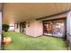 View of patio space with artificial turf and sliding glass doors leading to the home at 365 Leisure World --, Mesa, AZ 85206