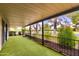 Covered patio featuring an artificial grass floor with wrought iron railing offering tranquil community views at 365 Leisure World --, Mesa, AZ 85206