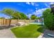 Serene backyard with artificial grass, pool, shed and lounge area at 3710 E Altadena Ave, Phoenix, AZ 85028
