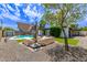 Inviting backyard features a sparkling pool, lush greenery, and a comfortable outdoor seating area perfect for relaxation at 3710 E Altadena Ave, Phoenix, AZ 85028