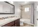 This bathroom offers tiled walls, a dark wood vanity, and a shower and tub combo at 3710 E Altadena Ave, Phoenix, AZ 85028