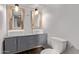 Modern bathroom with double sinks, stylish mirrors, and tile floors, offering a sleek design at 3710 E Altadena Ave, Phoenix, AZ 85028