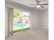 Bright bedroom with sliding glass doors that offer pool views and a modern ceiling fan at 3710 E Altadena Ave, Phoenix, AZ 85028