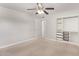 This bedroom features neutral walls, plush carpet, a ceiling fan, and a closet at 3710 E Altadena Ave, Phoenix, AZ 85028