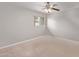 This bedroom features neutral walls, plush carpet, a large window, and a ceiling fan at 3710 E Altadena Ave, Phoenix, AZ 85028