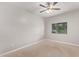 This bedroom features neutral walls, plush carpet, and a ceiling fan at 3710 E Altadena Ave, Phoenix, AZ 85028