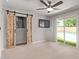 This bedroom features plush carpet, a television, barn doors, and sliding glass doors leading to the pool at 3710 E Altadena Ave, Phoenix, AZ 85028