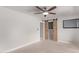 This bedroom features neutral walls, plush carpet, sliding barn door and a ceiling fan at 3710 E Altadena Ave, Phoenix, AZ 85028