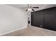 This bedroom features carpet, a ceiling fan, and a modern design at 3710 E Altadena Ave, Phoenix, AZ 85028