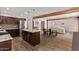 Spacious kitchen with a central island, wood beam accents, and stainless steel appliances at 3710 E Altadena Ave, Phoenix, AZ 85028