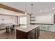 Kitchen with island and seating opens to living room, offering great space for entertaining at 3710 E Altadena Ave, Phoenix, AZ 85028