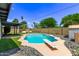 Sparkling pool with diving board surrounded by lush landscaping at 3710 E Altadena Ave, Phoenix, AZ 85028