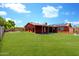 Expansive backyard with lush green lawn, perfect for outdoor activities and relaxation with the home in the background at 3723 W Columbine Dr, Phoenix, AZ 85029