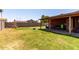 Large backyard featuring a covered patio, ample green space, and block fence at 3723 W Columbine Dr, Phoenix, AZ 85029