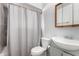 Compact bathroom featuring a shower with a curtain, a toilet, and a sink at 3723 W Columbine Dr, Phoenix, AZ 85029
