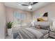 Comfortable bedroom featuring a cozy bed, stylish decor, and a large window at 3723 W Columbine Dr, Phoenix, AZ 85029