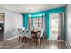 Dining area with table, chairs, large windows, and bright accent wall paint at 3723 W Columbine Dr, Phoenix, AZ 85029