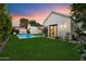 Expansive backyard featuring a modern pool and lush green lawn, perfect for outdoor enjoyment at 3808 E Fairmount Ave, Phoenix, AZ 85018