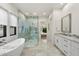 Luxurious bathroom complete with a freestanding tub, glass-enclosed shower, and elegant double vanity at 3808 E Fairmount Ave, Phoenix, AZ 85018