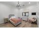 Charming bedroom features a stylish chandelier, wood floors, and cozy decor at 3808 E Fairmount Ave, Phoenix, AZ 85018