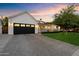 Captivating curb appeal with a sleek black garage door, well-manicured lawn, and modern exterior lighting at 3808 E Fairmount Ave, Phoenix, AZ 85018