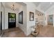 Bright foyer featuring a modern chandelier, black framed doorway and views into the kitchen at 3808 E Fairmount Ave, Phoenix, AZ 85018