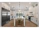 Modern white kitchen featuring stainless steel appliances, marble countertops, and a large center island with seating at 3808 E Fairmount Ave, Phoenix, AZ 85018