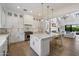 Bright kitchen features white cabinets, marble countertops, stainless steel appliances, and an island with barstool seating at 3808 E Fairmount Ave, Phoenix, AZ 85018